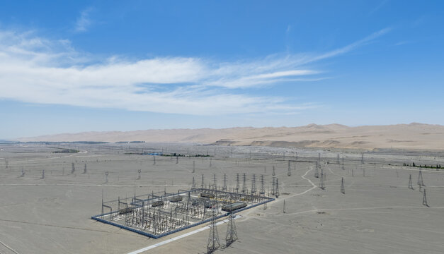 Aerial View of Electrical Substation and Power Transmission Towers in Desert Landscape
