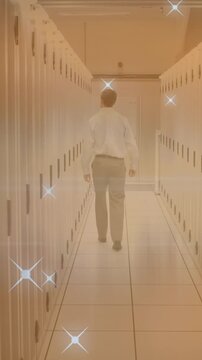 Animation of moving stars and caucasian male worker over server room