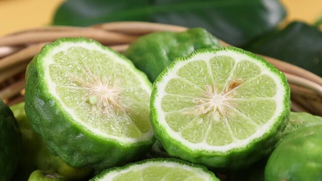 Fresh kaffir limes arranged in a basket