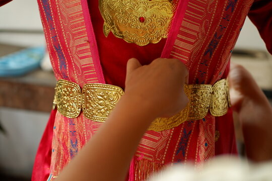 Close-up of woman hands wearing handcrafted gold accessories for ceremony
