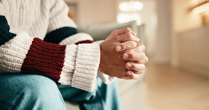 Anxiety, hands and man on sofa in home for stress, trauma and mental health in living room. Nervous, overthinking and person with stimming for phobia, panic attack or pressure for bad news in house.