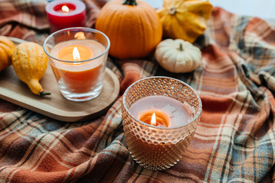 Cozy autumn still life with pumpkins and burning candles