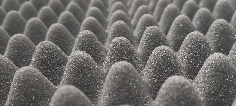 Materials that absorb sound waves instead of blocking them.