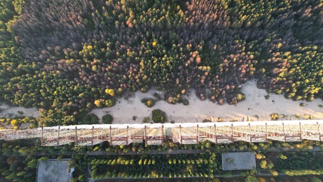 Aerial view of the Duga radar array surrounded by dense pine forests and sandy terrain in Ivankivs'kyi district, Kyiv Oblast, Ukraine.