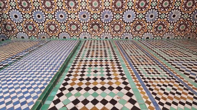 Rosette dado meeting a striped zellij floor, Saadian Tombs, Marrakech, Morocco, geometric tilework in even indoor ligh