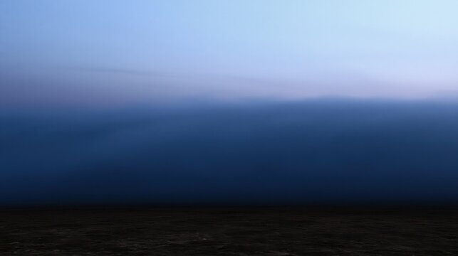Dark fog bank rolling in at dusk over a dark landscape