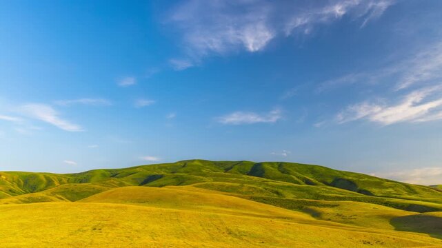 time lapse of clouds flying above green mountains in Kyrgyzstan at summer evening