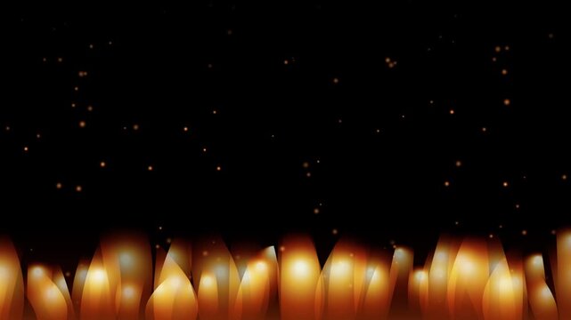Glowing orange fire flames and rising amber spark particles on a dark background - 4K video