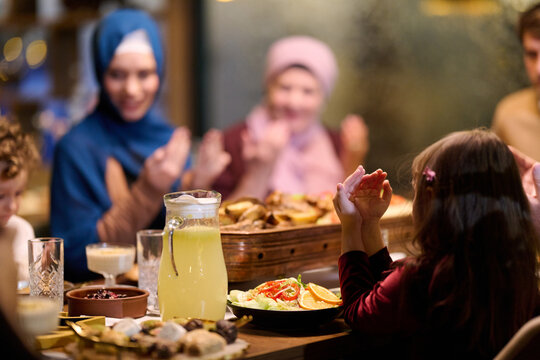 Family Dinner Celebration With Children and Women in Hijab Sharing a Festive Meal Together