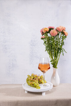 Rose wine glass, grapes, aster flowers still life