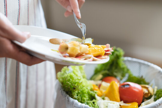 Food waste environment concept, people throwing food garbage into bin prepare to decompose