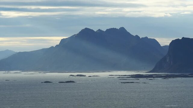Sunlight raking across a steep coastal massif, Lofoten, Nordland, Norway