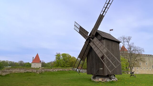Wooden windmill and historic Kuressaare Castle in Estonia