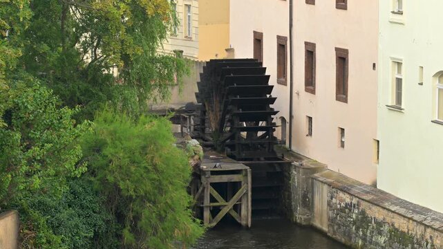 Old wooden water wheel turning in Prague