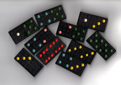 A close up detail of black vintage dominoes.