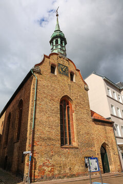 Flensburg, Germany - 17. August 2026: Old brick church building with green spire