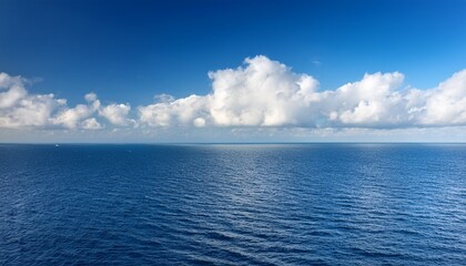 Fototapeta premium White Clouds At The Blue Sea Horizon