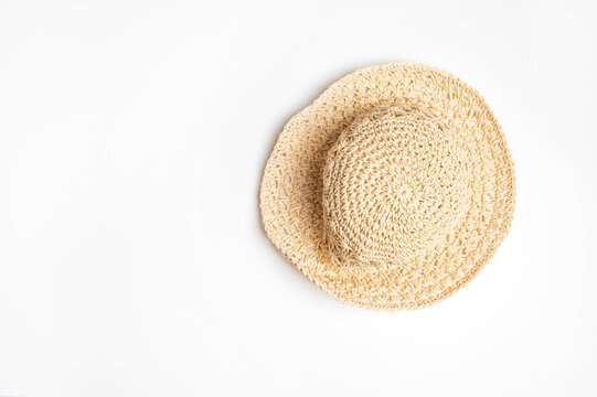 Straw panama hat on white background shows soft woven texture and relaxed shape. Neutral styling suits summer campaigns, travel content, accessory catalogs, retail layouts, and lifestyle branding.