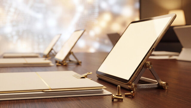 Tablets with blank screens stand on a wooden surface waiting for creative design implementation.