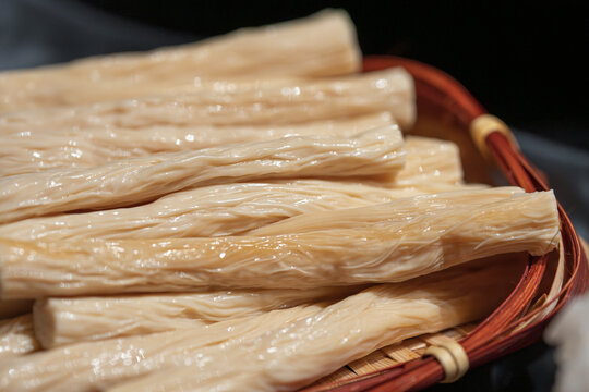 Soaked dried bean curd sticks in bamboo woven winnowing basket