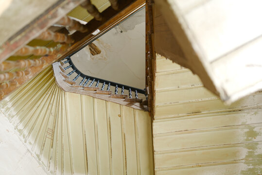 Old Abandoned Spiral Staircase in Dilapidated House
