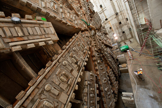 Construction white workers inspect a tunnel boring machine