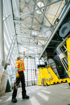 A construction white worker points