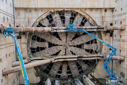 A tunnel boring machine undergoing maintenance at a construction site