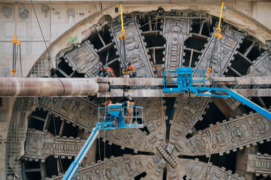 Construction workers operating a tunnel boring machine