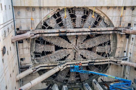 Construction white workers operate tunnel boring machine