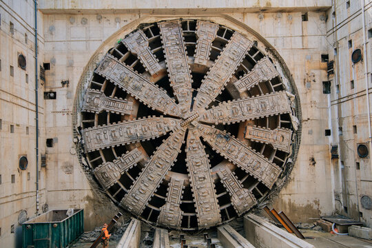 A large tunnel boring machine stands in a construction site