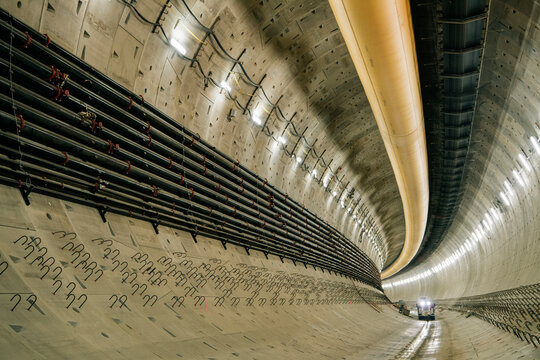 Interior of a tunnel under construction with utility pipes