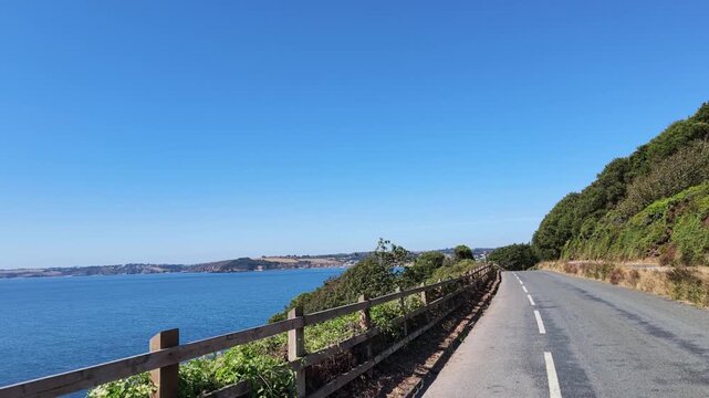 Falmouth Cornwall UK. 13.08.2026. Video. Driving along clifftop road with a seaview and Castle Beach Falmouth in slow motion.