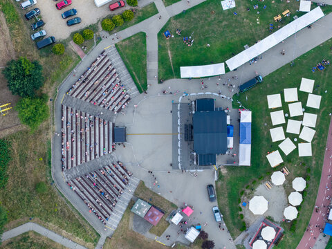 Aerial view of an outdoor summer festival with stage, seating, and food tents