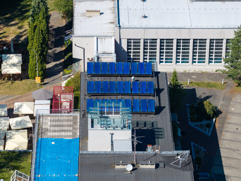 Rooftop solar thermal panels generating renewable energy on modern building