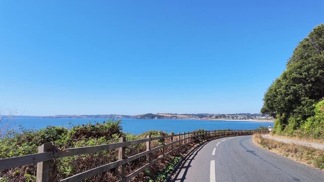 Falmouth Cornwall UK. 13.08.2026. Video. Driving along clifftop road with a seaview and Castle Beach Falmouth in slow motion.