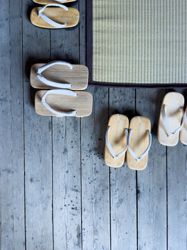 Traditional Japanese wooden geta and zori footwear on floor
