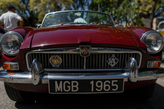 Tavernes Blanques, Spain - June 14, 2026.Maroon MGB Roadster shows radiator grille and badges in a sunny setting