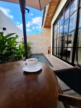 Coffee on a table beside a swimming pool in La Union, Philippines