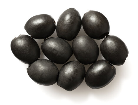 Pitted black olives isolated on white background, top view.