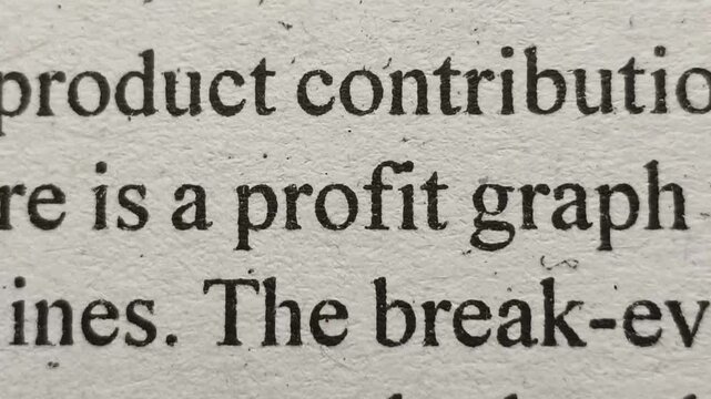Closeup of profit word printed on news articles, books or magazine white pages emphasized and highlighted. Business and company profit financial revenue increase or decrease concept.