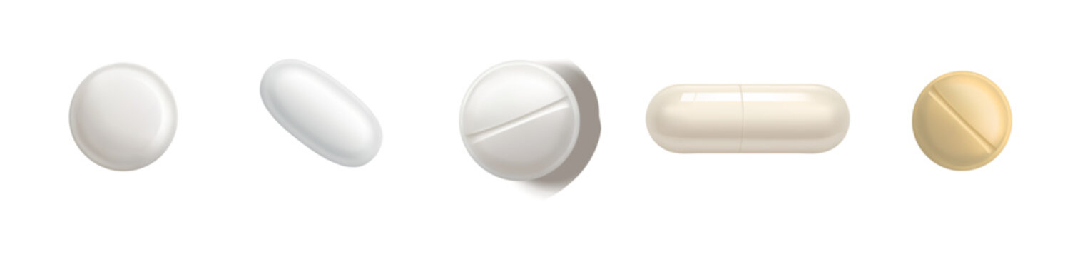 Assortment of white and yellow pills and capsules on a white background