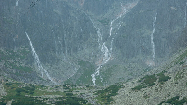 carpathians lomnicky stit peak high tatras mountains temporary waterfall after heavy rain cloudy weather atmosphere dramatic landscape nature exploration tourism concept of weather, travel, adventure,