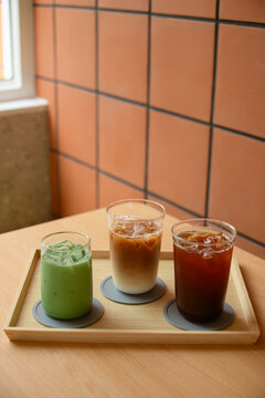 Green tea and coffee in plastic cups on tables, not in cafes.