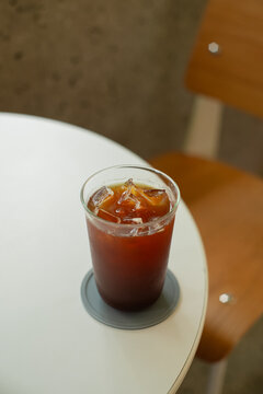 Green tea and coffee in plastic cups on tables, not in cafes.