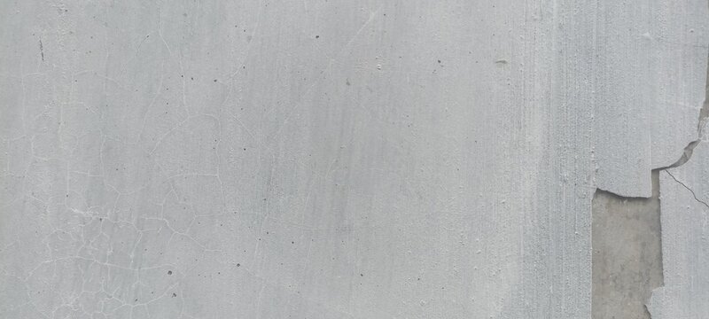 Peeling plaster wall texture with fine web cracks and exposed concrete base, suitable for architectural renovation concepts, industrial backdrops, and urban banners