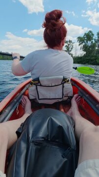 Redhead Woman Rowed in Orange Kayak on Scenic River Point of View Perspective