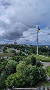 Ukrainian flag over Kyiv city vertical video