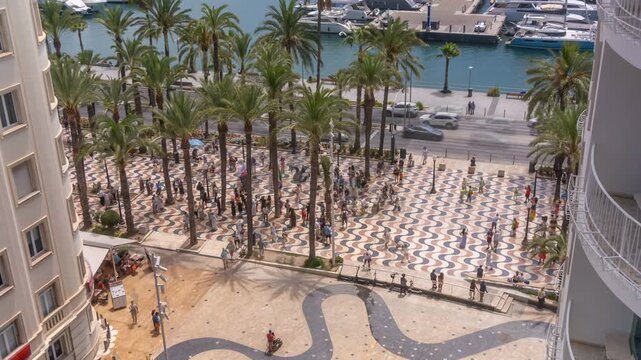 Time lapse of Explanada of Spain during 'Parade of the Giants' from elevated viewpoint on a sunny day, Alicante, Costa Blanca, Spain