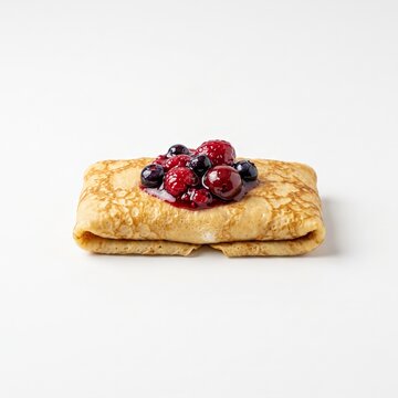 Cheese blintz topped with berry compote on white background